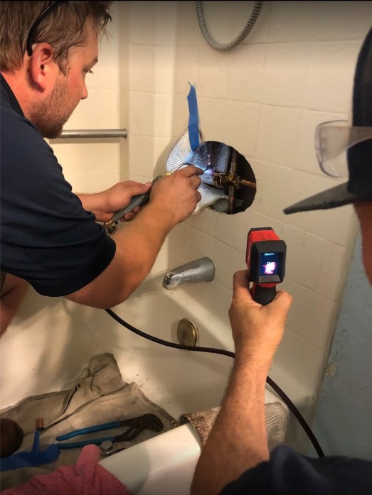 Plumbing contractor fixing bathtub faucet